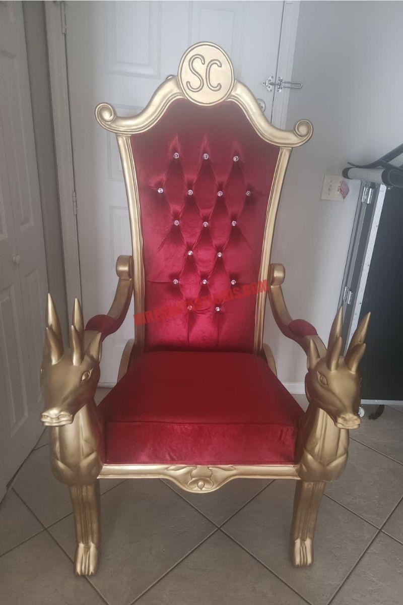 Santa chair photos in St. Louis: gold chair with a red tufted back and reindeer armrests on beige tile.